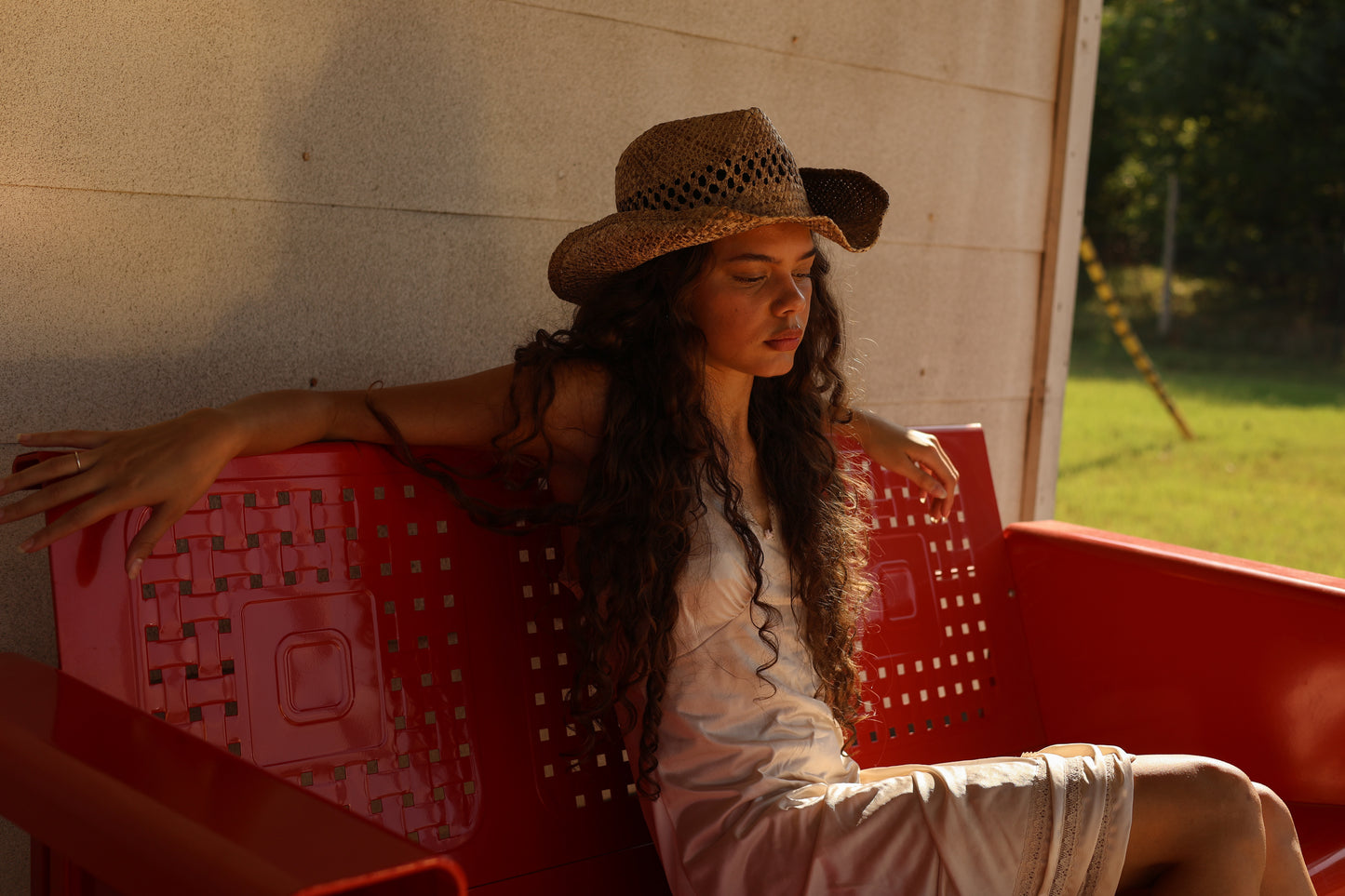 Vintage ivory satin lace slip dress from 1990s styled with western boots and straw hat, photographed in rustic country porch