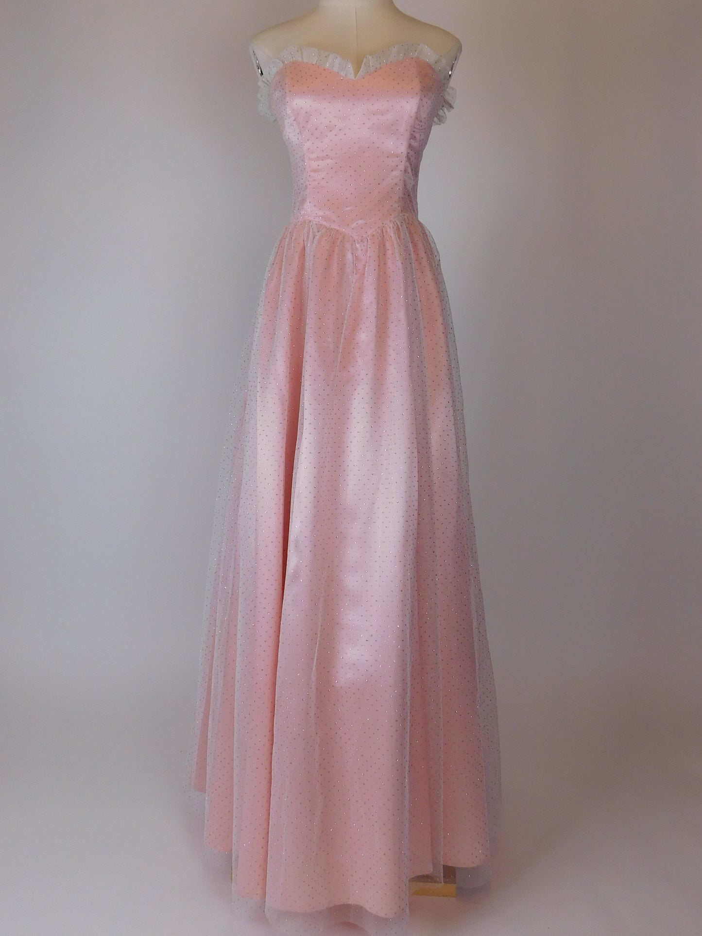 Full-length 1980s Gunne Sax Jessica McClintock pink satin strapless gown displayed on mannequin studio backdrop