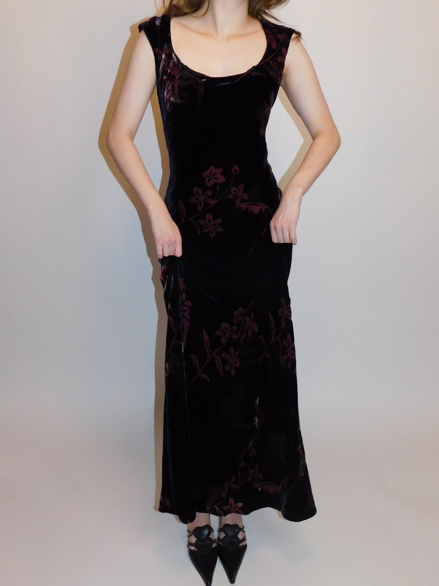 90s vintage floral burnout velvet dress with scoop neck and body-hugging fit, model lifting hem slightly to show movement
