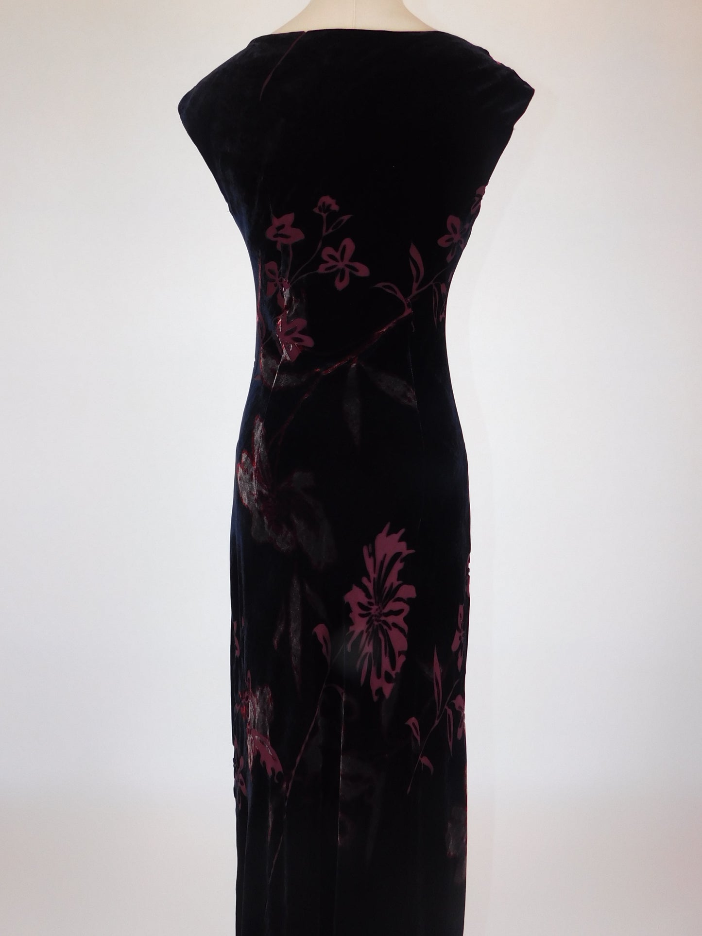 Back detail of floral devoré silk velvet dress on mannequin, showing large floral motif and zip closure