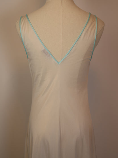 Close-up of back neckline on 1970s white satin slip dress with mint trim, soft sheer vintage lingerie detailing
