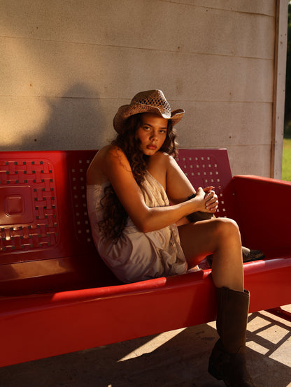 1990s ivory satin lace slip dress with western boots and hat, sunlit outdoor setting evoking vintage prairie aesthetic
