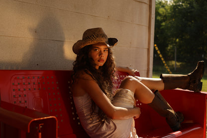 Vintage-inspired 1990s ivory satin slip dress with lace trim styled western chic, red bench and golden hour backdrop
